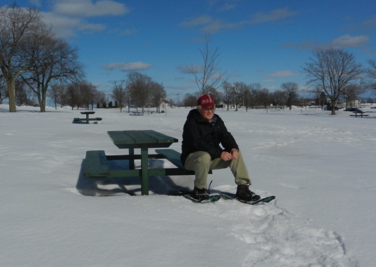 taking a break on a bench from snowshoeing