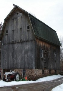 Snowmobiles now do a lot of the work tractors accomplished in snowstorms of the past. However, nothing is more serene than a barn with its tractor.