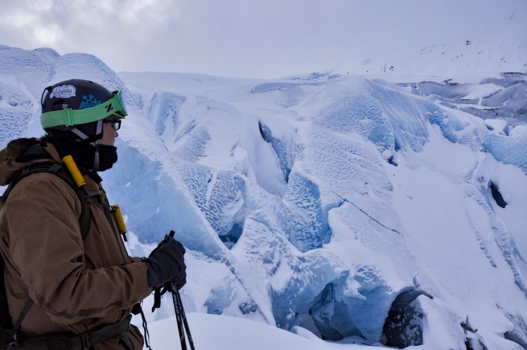 man inspecting snowy icebergs