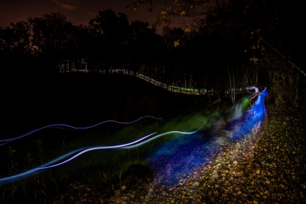 Racers creating a colorful display by surfing the course before dawn