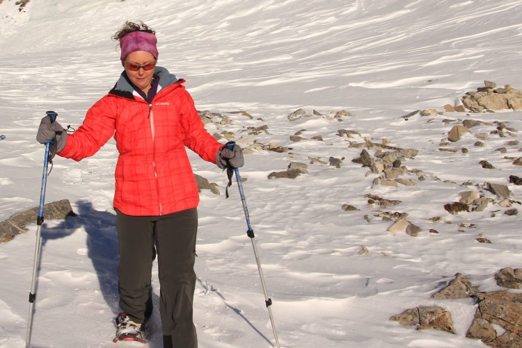 Columbia Whirlibird Interchange Jacket: person snowshoeing with poles in bright jacket