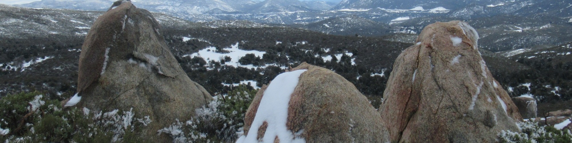view from a mountain top with boulders in foreground