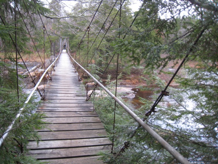Bridge with water and rocks to left and right.
