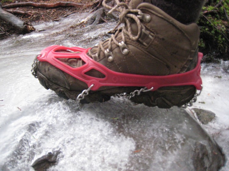 Kahtoola Microspikes: close up of foot with traction device on icy ground