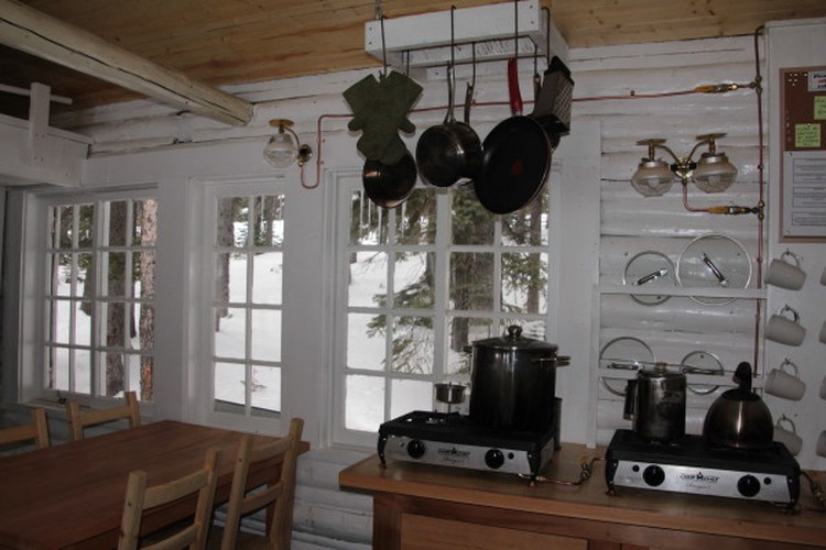 kitchen with pans hanging from ceiling