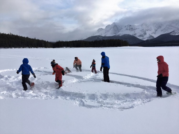 people playing tag on snowshoes