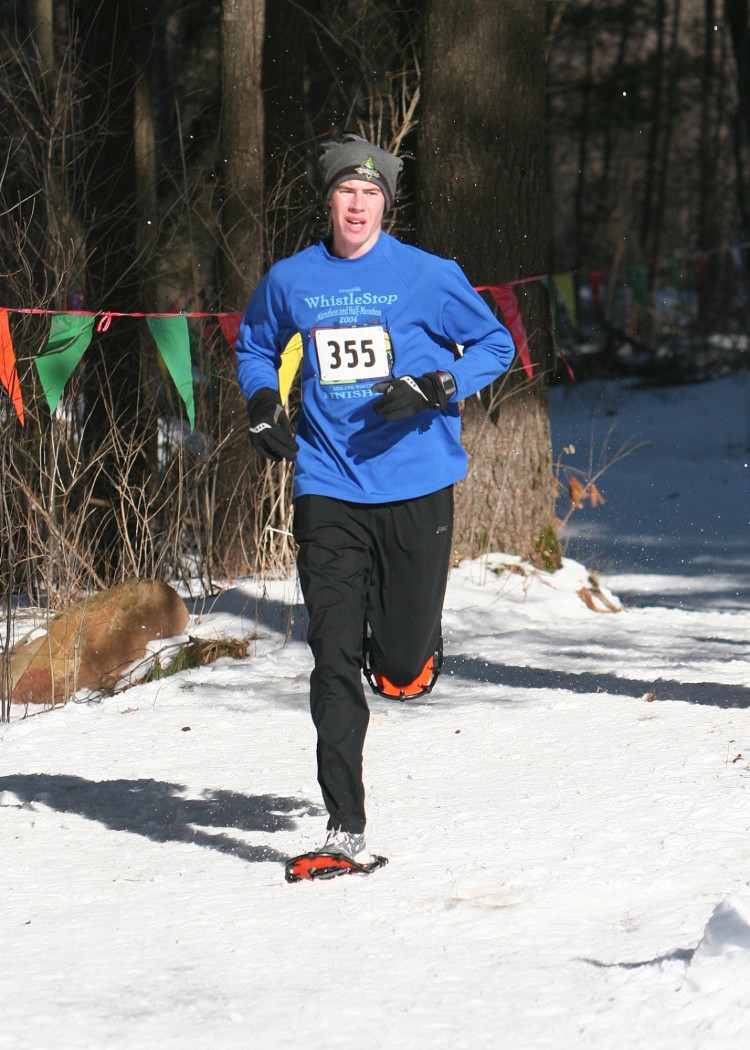 man on snowshoes running in a race
