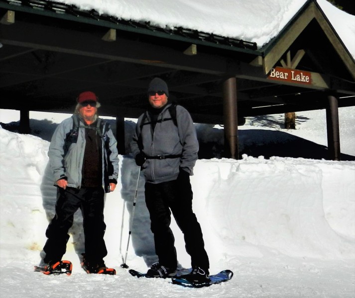 two men standing near snowy ranger station