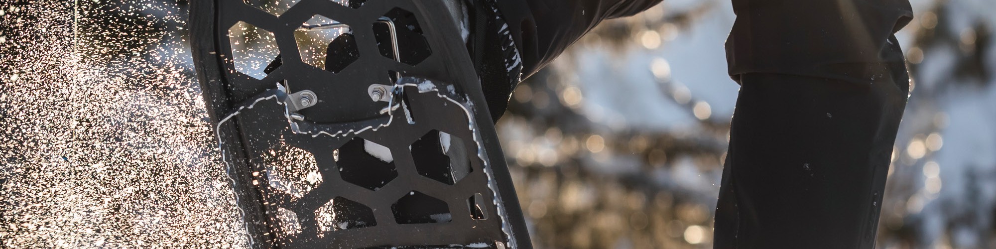 person snowshoeing with carbon air frame snowshoe in air