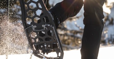 person snowshoeing with carbon air frame snowshoe in air