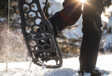 person snowshoeing with carbon air frame snowshoe in air