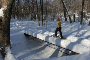 man on bridge with traditional snowshoes