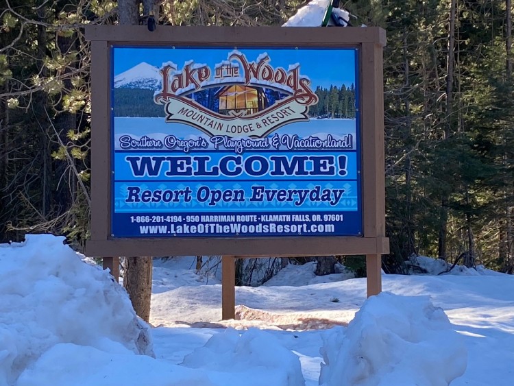 sign for Lake of the Woods Resort surrounded by snow