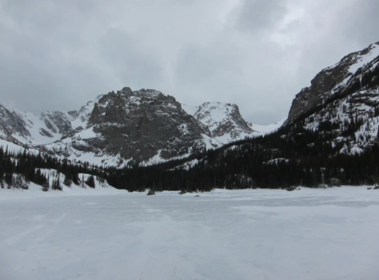 snowshoeing Rocky Mountain National Park: view of a lake covered with snow and mountains in background