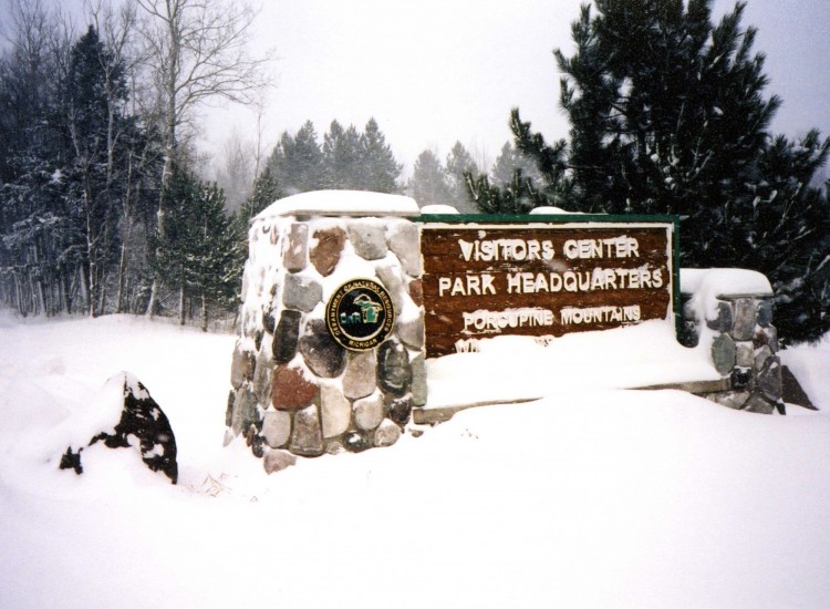 snow covered signed to the visitor center in the Porcupine Mountains