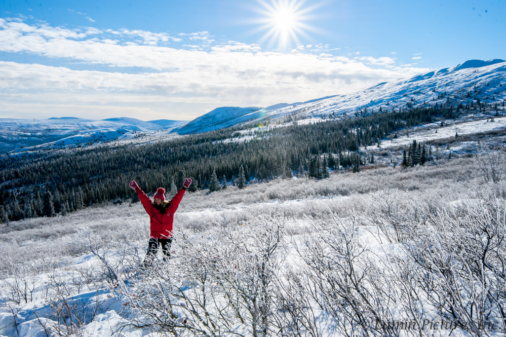 woman standing in Bonneville Ridge, Yukon under blue sky in winter