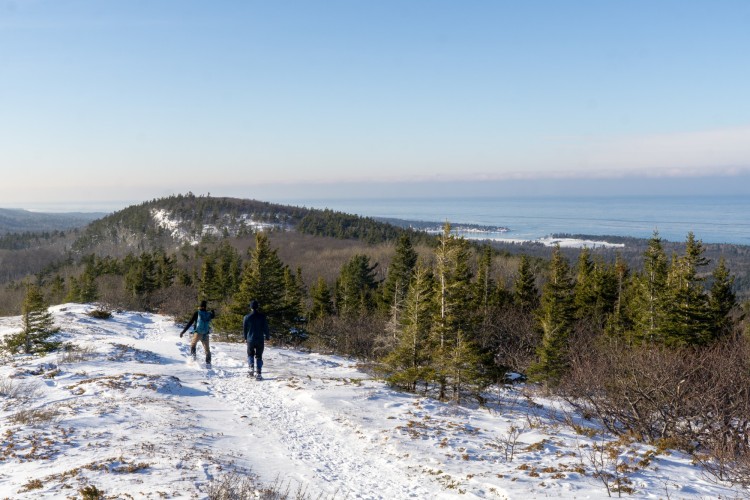 aerial view of the top of Mt Baldy with lake and snowshoers in background