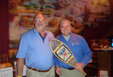 two men holding snowshoe award