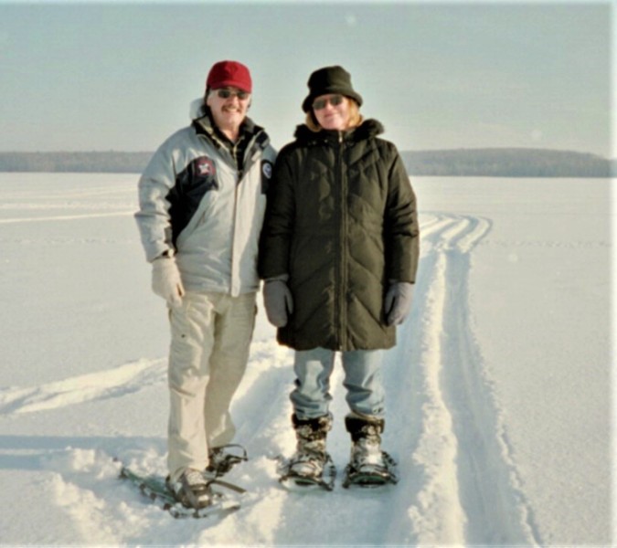 2 people standing on snowshoes in snow