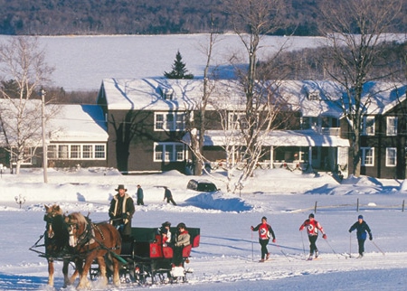 sleigh ride and skiers in front of inn