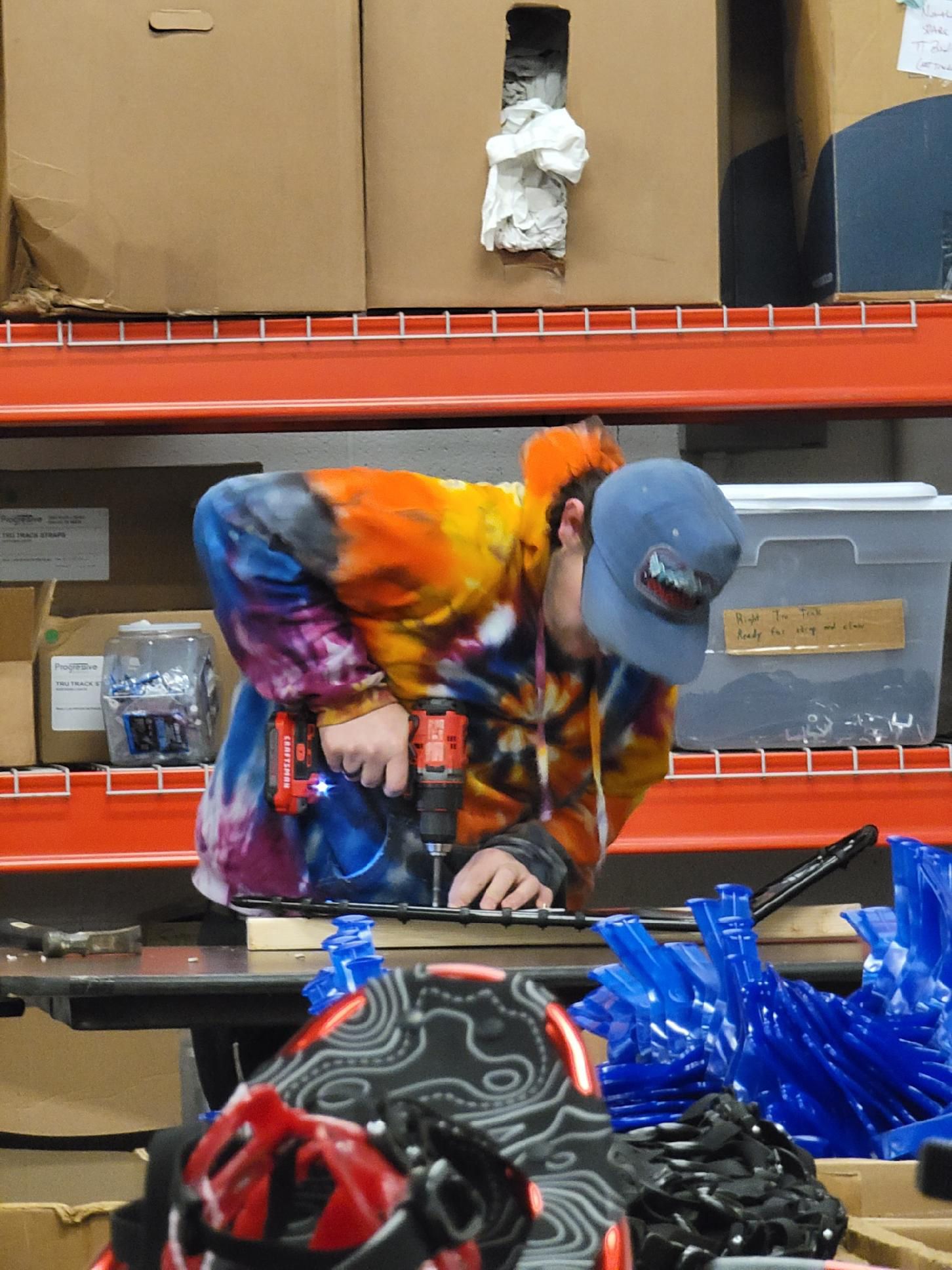 person crafting a pair of snowshoes in factory