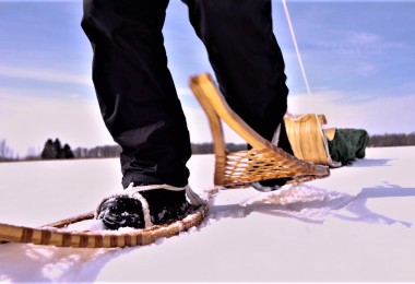 focus on feet in traditional wooden snowshoes
