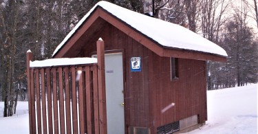 outhouse surrounded by snow