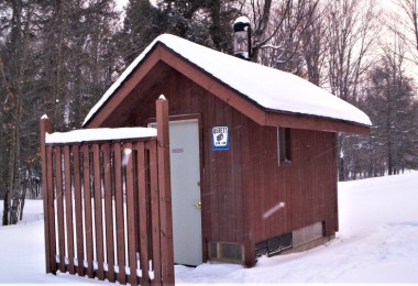 outhouse surrounded by snow