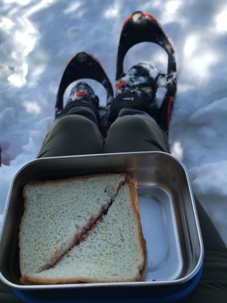 snack container with snowshoes and snow in background