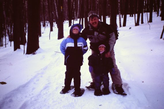 outdoor journaling: grandfather with grandchildren while snowshoeing