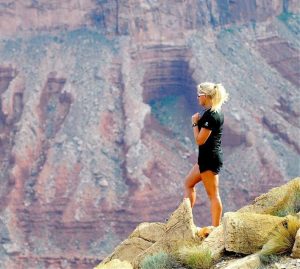wilderness athlete woman posing on mountainside