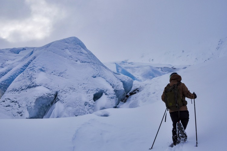 person snowshoeing near glacier in Alaska