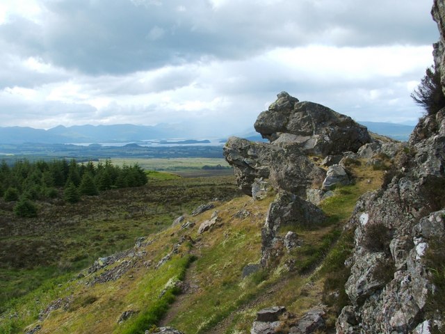 the Whangie rock formation with open sky and trees in background