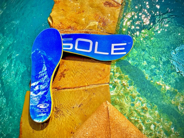 SOLE insoles sitting on rock near pool