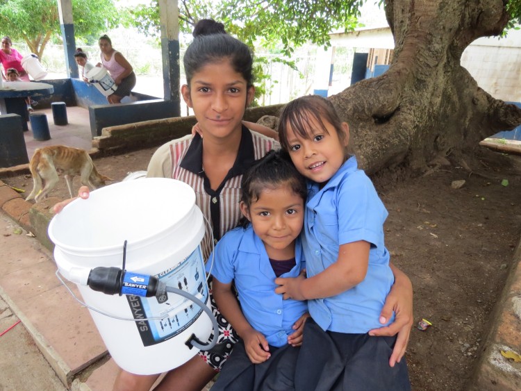 family posing for photo with Sawyer bucket system