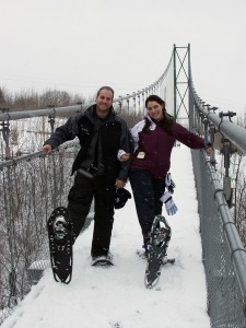 Snowshoeing across the great suspension bridge at Scenic Caves Nordic Center.