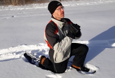 person demonstrating lunge on snowshoes in the snow