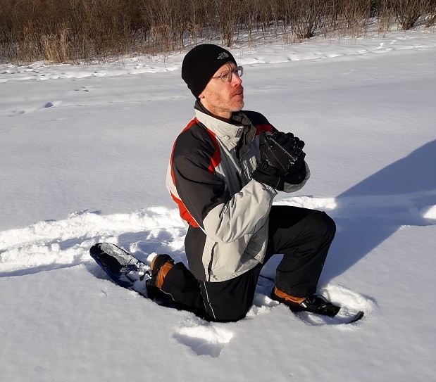 person demonstrating lunge on snowshoes in the snow