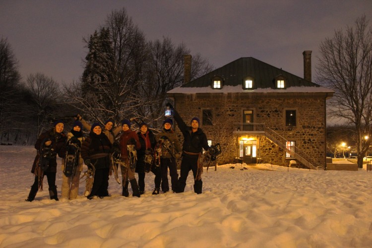 snowshoeing in Montreal: snowshoers posing for photo in front of Smith's House