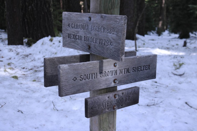 trail sign for snowshoeing at sno-park near lake of the woods intersection with snow in background