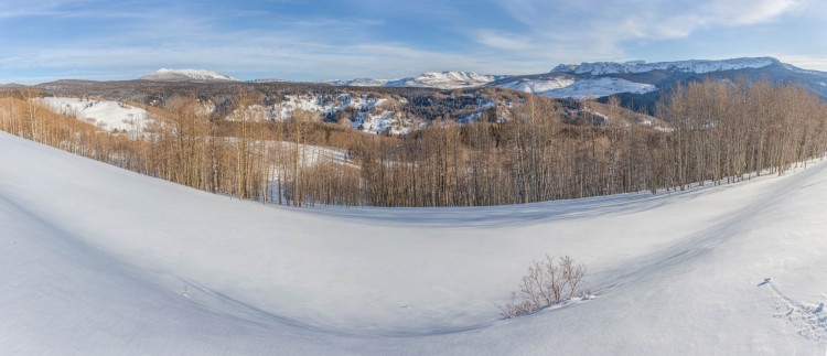 panorama with snow in foreground and mountains in back