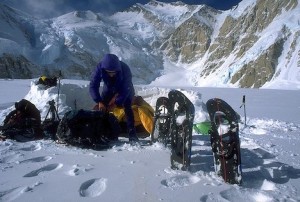 Photo of mountaineer checking his equipment at base camp
