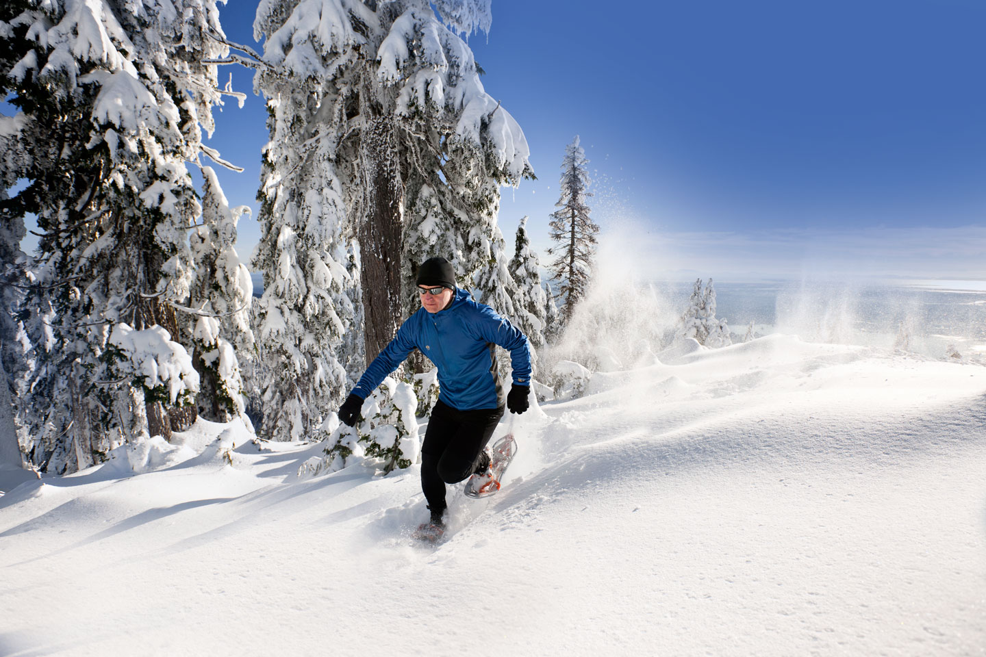 man running in the snow at Grouse Mountain