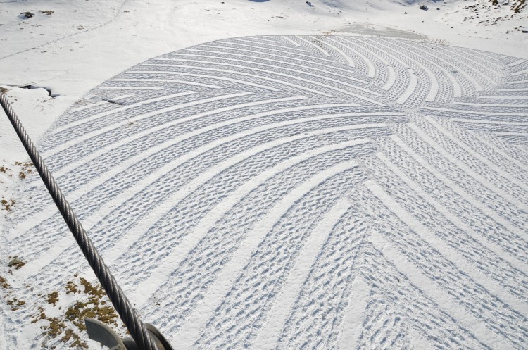 geometric art in the snow underneath a ski lift