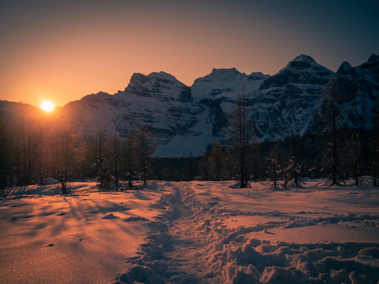 snowshoe trail with sunset over mountain