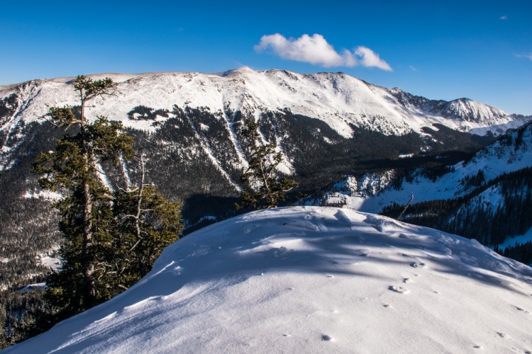 view of snowy peak with blue sky overhead