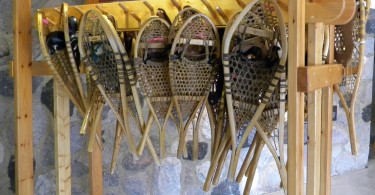 traditional snowshoes hanging on wooden rack