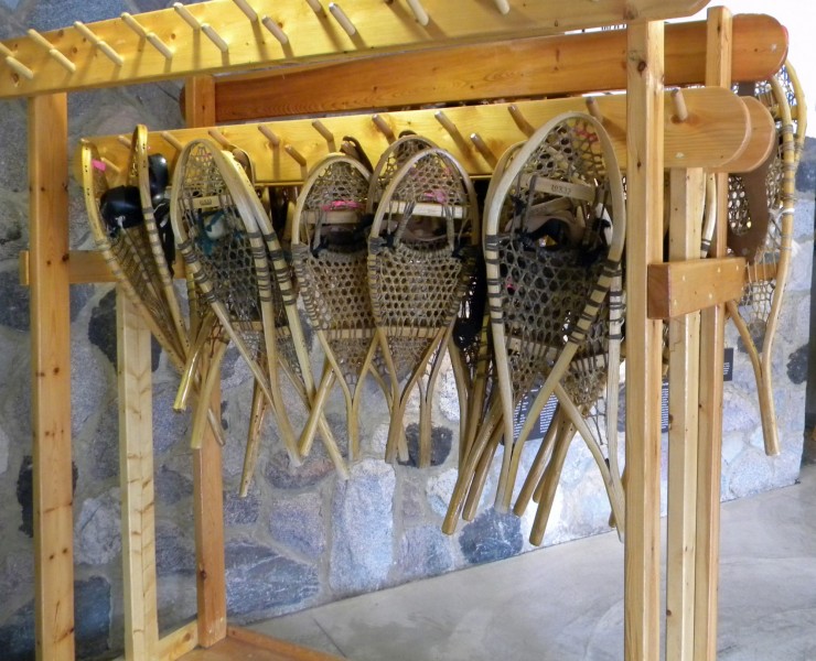 traditional snowshoes hanging on wooden rack