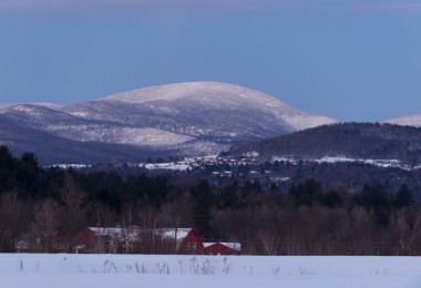 view of a lodge in distance with snowy hill in background