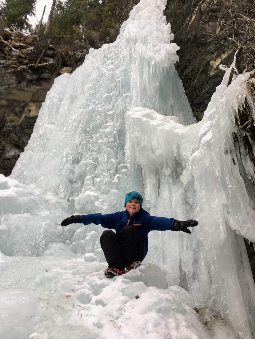 child with arms extended on Troll Falls, Kananaskis